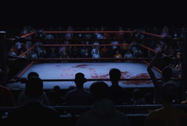 Wrestling audience around a wrestling ring.